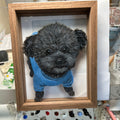 Pet portrait glass painting displayed on mantelpiece with warm lighting